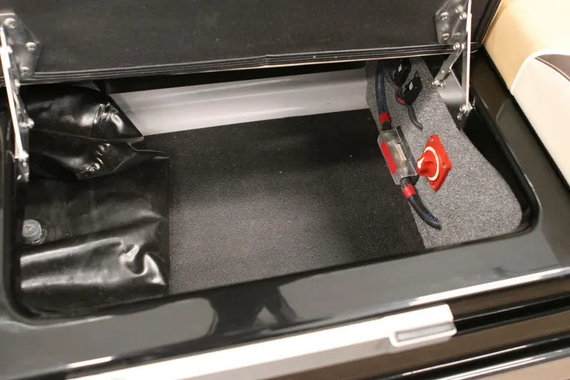 Slide: The Image of 2018 Supra SR400 storage compartment with wiring and black interior. - 94