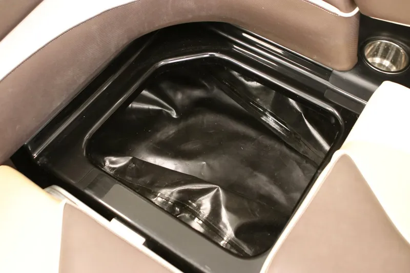 Slide: The Image of 2018 Supra SR400 interior storage compartment with black lining and cup holder. - 95