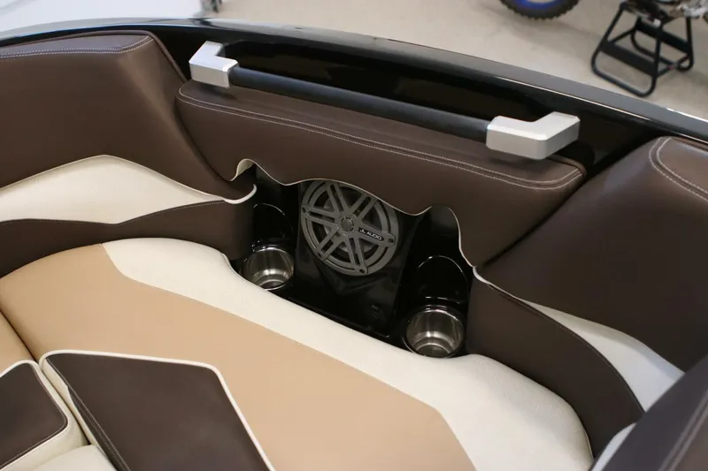Slide: The Image of 2018 Supra SR400 interior with brown and beige seating, JL Audio speaker, and cup holders. - 10