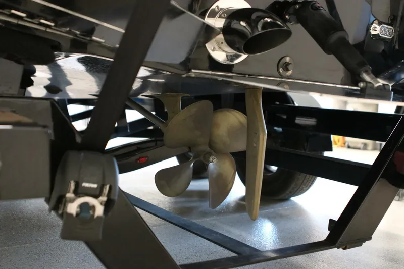 Slide: The Image of Close-up of 2018 Supra SR400 boat propeller and rudder system in a garage setting. - 110