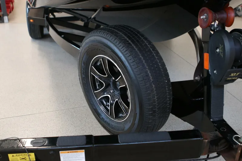 Slide: The Image of 2018 Supra SR400 trailer wheel with black alloy rim in a showroom. - 116