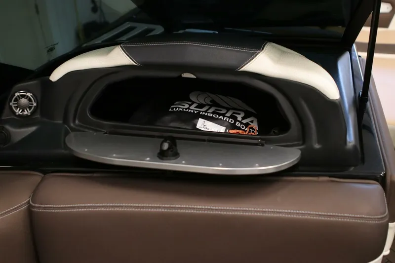 Slide: The Image of 2018 Supra SR400 boat storage compartment with luxury inboard branding. - 21