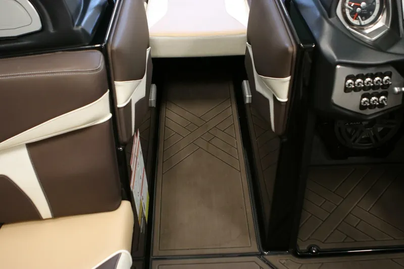 Slide: The Image of 2018 Supra SR400 interior with brown and beige seating, dashboard controls, and patterned flooring. - 23