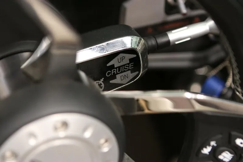 Slide: The Image of Close-up of 2018 Supra SR400 cruise control lever with "UP" and "DN" options. - 43