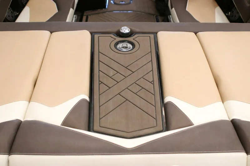 Slide: The Image of 2018 Supra SR400 boat interior with beige and brown cushioned seating. - 56