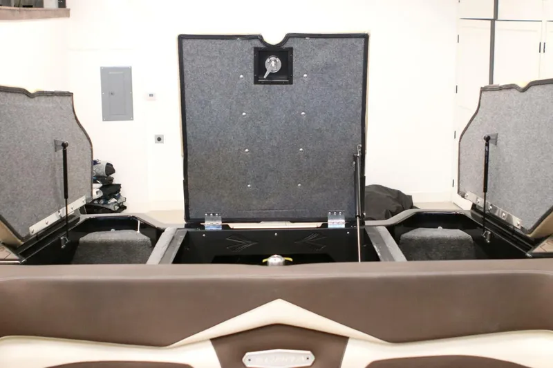 Slide: The Image of 2018 Supra SR400 boat storage compartments open in a garage setting. - 70