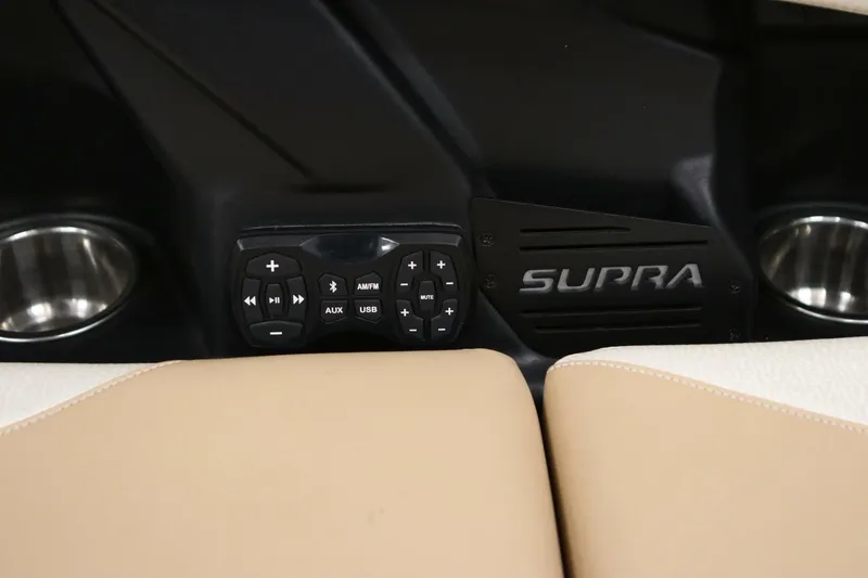 Slide: The Image of 2018 Supra SR400 interior with audio controls and cup holders. - 74