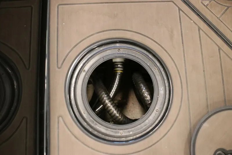 Slide: The Image of 2018 Supra SR400 boat deck with open hatch revealing coiled hoses. - 88