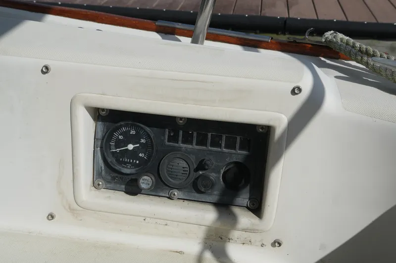 Slide: The Image of Control panel of a 1985 Pearson 303 sailboat, featuring gauges and switches. - 11