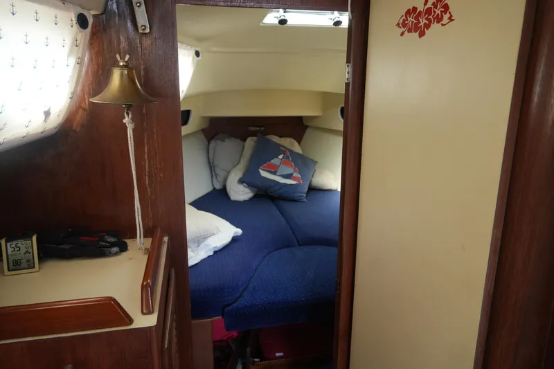 Slide: The Image of Cozy cabin interior of 1985 Pearson 303 sailboat with nautical decor and bedding. - 15