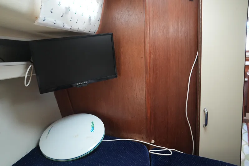 Slide: The Image of Interior of 1985 Pearson 303 sailboat with TV and satellite dish. - 16