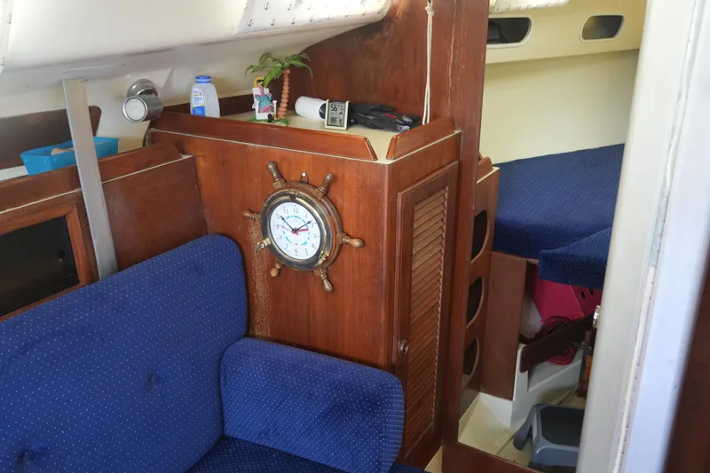 Slide: The Image of Interior of 1985 Pearson 303 sailboat with nautical decor and blue upholstery. - 21