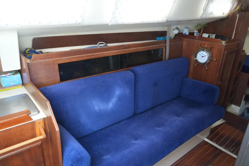 Slide: The Image of Interior of 1985 Pearson 303 sailboat with blue sofa and nautical decor. - 23