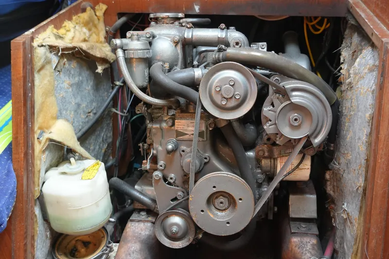 Slide: The Image of Engine compartment of a 1985 Pearson 303 sailboat, showing mechanical components and insulation. - 28