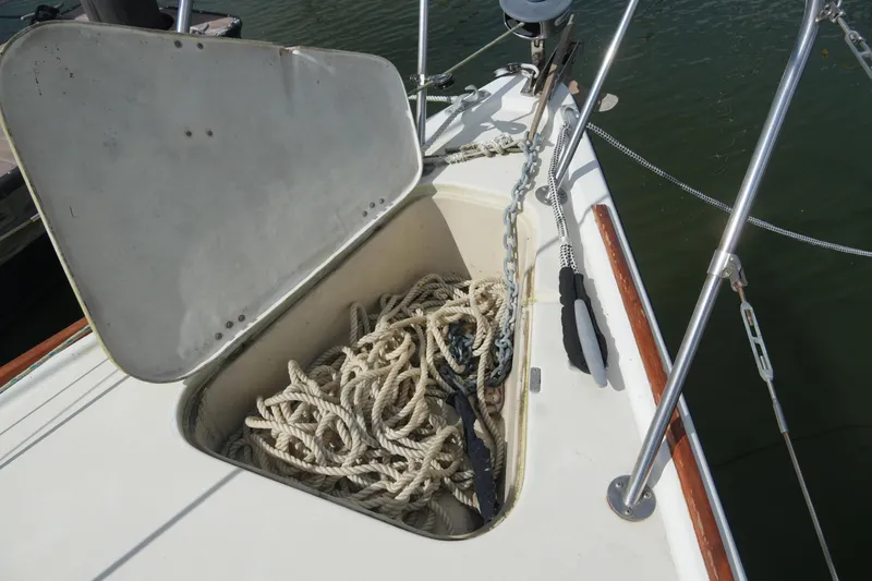 Slide: The Image of Open anchor locker on 1985 Pearson 303 sailboat with ropes and chain. - 6