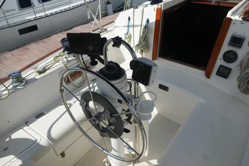 Slide: The Image of Cockpit of 1985 Pearson 303 sailboat with steering wheel and navigation equipment. - 9