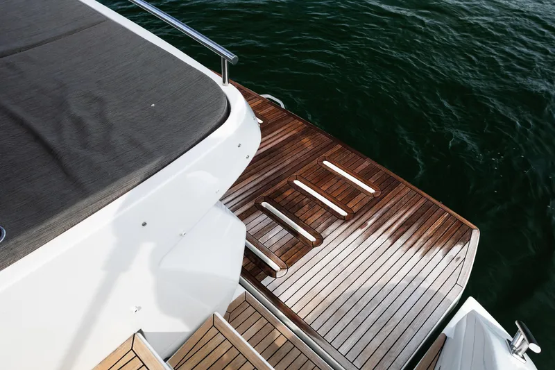 Slide: The Image of 2019 Azimut Atlantis 43 yacht with elegant wooden deck by the water. - 10