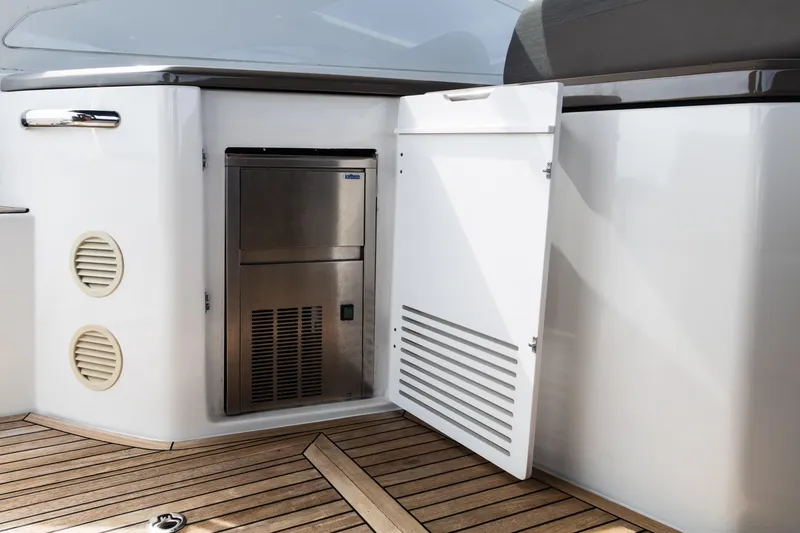 Slide: The Image of 2019 Azimut Atlantis 43 yacht interior with open storage compartment and wooden flooring. - 14