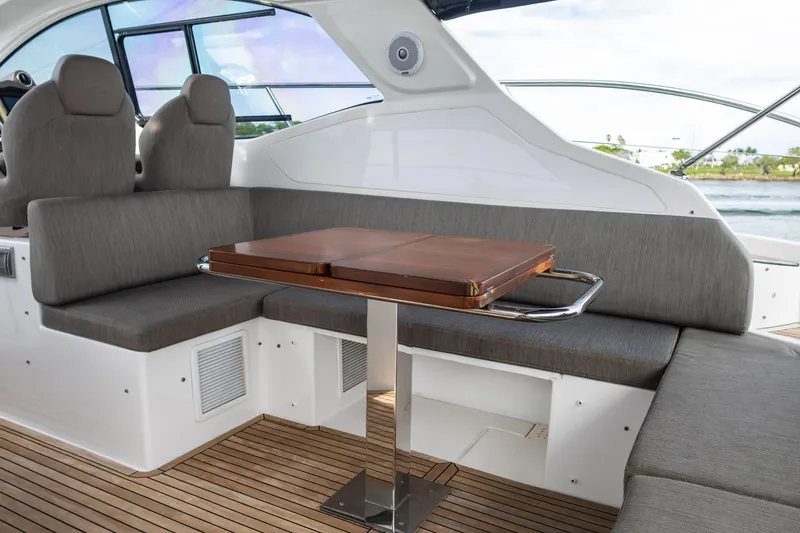 Slide: The Image of Luxurious seating area on 2019 Azimut Atlantis 43 yacht with wooden table and gray cushions. - 15