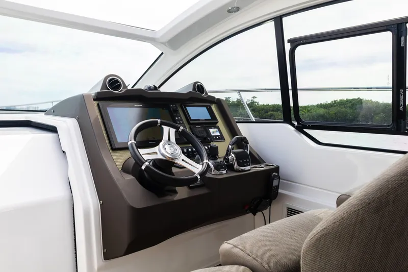 Slide: The Image of 2019 Azimut Atlantis 43 yacht helm with modern navigation controls and panoramic window view. - 16