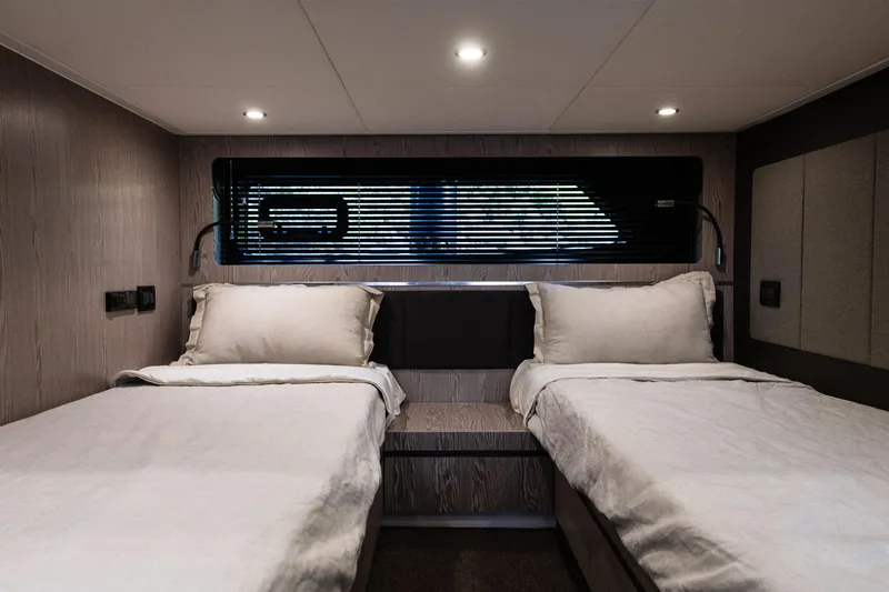 Slide: The Image of Interior of 2019 Azimut Atlantis 43 yacht with twin beds and modern lighting. - 35