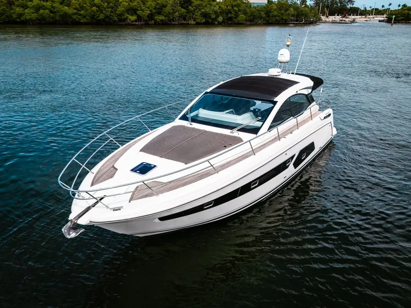 Slide: The Image of 2019 Azimut Atlantis 43 yacht on calm water, surrounded by lush greenery. - 6