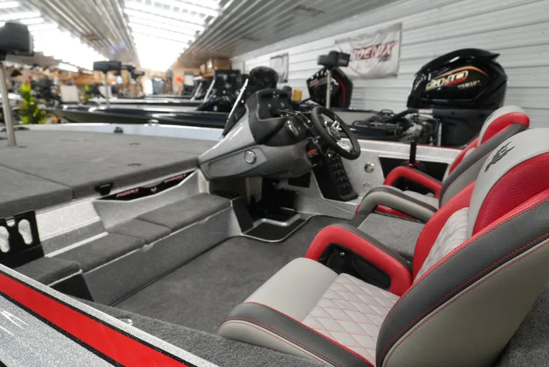 Slide: The Image of 2026 Phoenix 721 ZXL boat interior with red and gray seating, steering console, and spacious deck. - 11