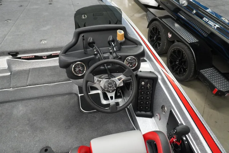 Slide: The Image of 2026 Phoenix 721 ZXL boat cockpit with steering wheel and control panel. - 12