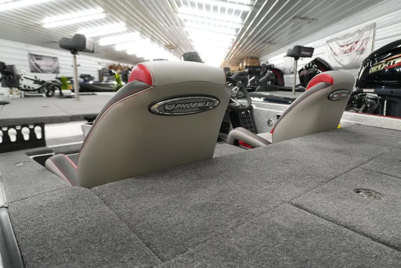 Slide: The Image of 2026 Phoenix 721 ZXL boat interior with gray and red seats in a showroom. - 21