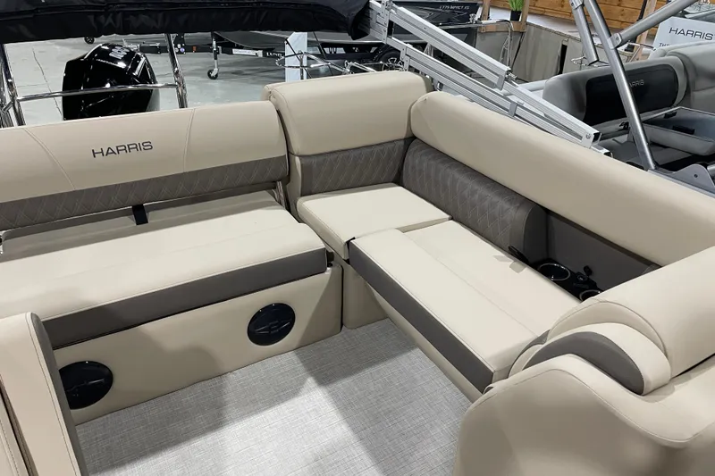 Slide: The Image of 2026 Harris Cruiser 210 boat interior with beige seating and cup holders. - 3