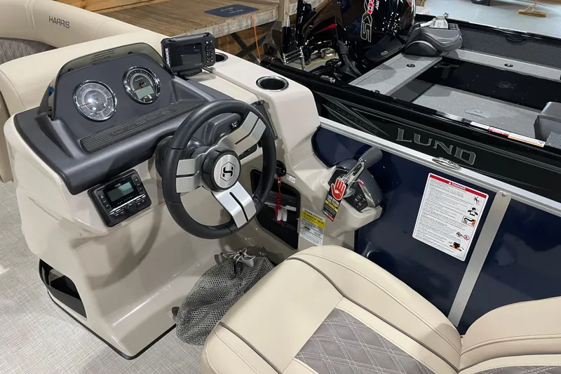 Slide: The Image of 2026 Harris Cruiser 210 boat dashboard with steering wheel and control panel. - 4