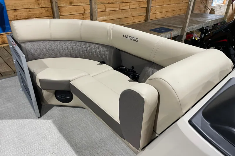 Slide: The Image of 2026 Harris Cruiser 210 boat interior with beige seating and cup holders. - 5