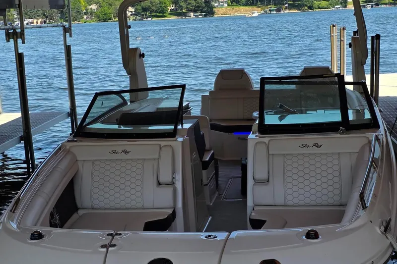 Slide: The Image of 2019 Sea Ray SDX 290 boat interior with lake view, featuring luxurious seating. - 10