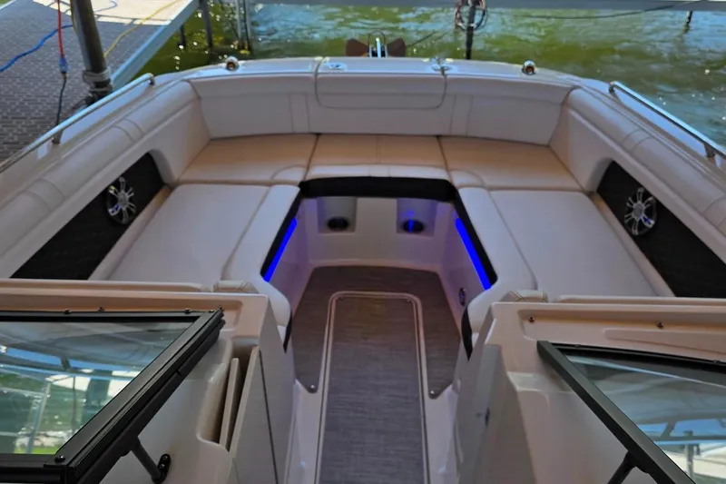Slide: The Image of 2019 Sea Ray SDX 290 boat interior with spacious seating and blue accent lighting. - 12