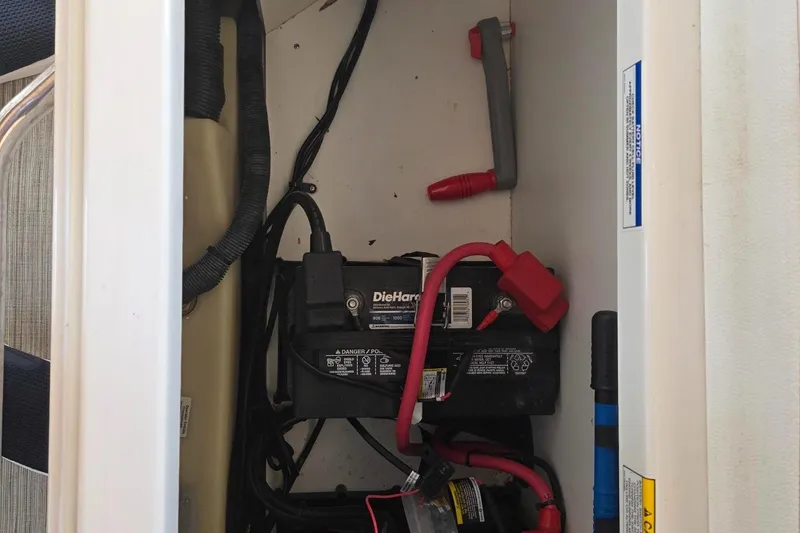Slide: The Image of Battery compartment of a 2019 Sea Ray SDX 290 boat, featuring DieHard battery. - 16