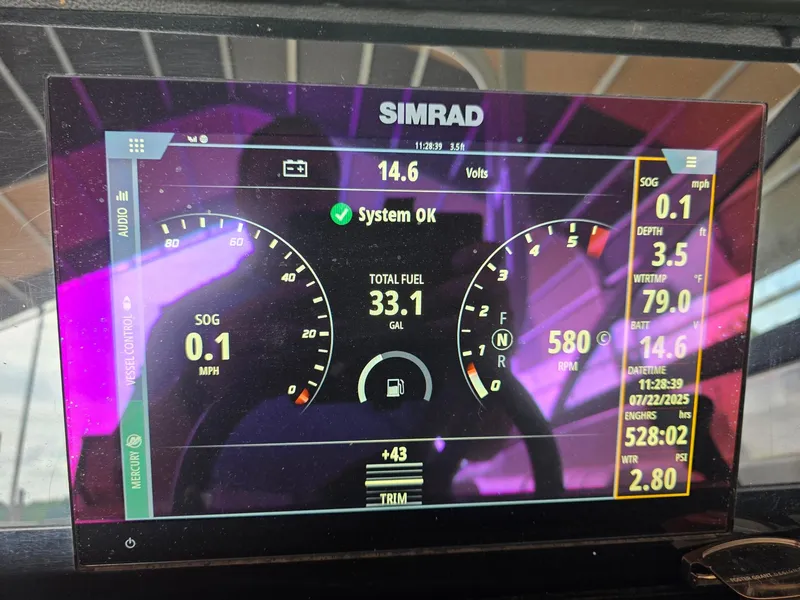 Slide: The Image of Simrad display on 2019 Sea Ray SDX 290 showing system status and navigation data. - 19