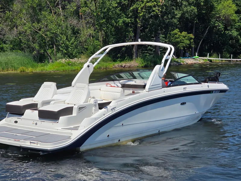 Slide: The Image of 2019 Sea Ray SDX 290 boat cruising on a lake with lush green trees. - 3