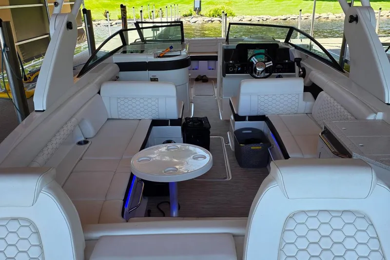 Slide: The Image of Luxurious 2019 Sea Ray SDX 290 boat interior with white seating and modern amenities. - 6
