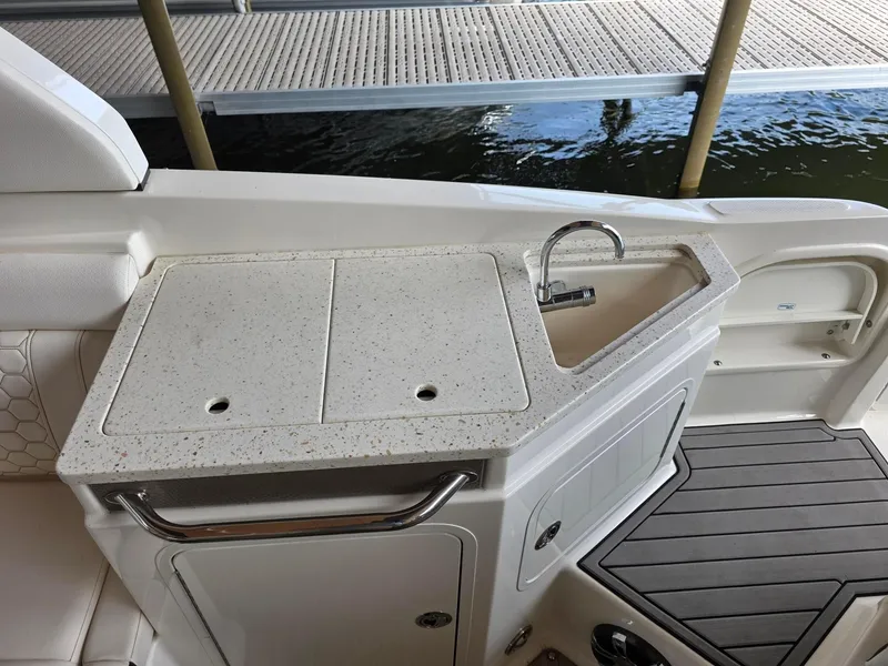 Slide: The Image of 2019 Sea Ray SDX 290 boat kitchenette with sink and countertop. - 7
