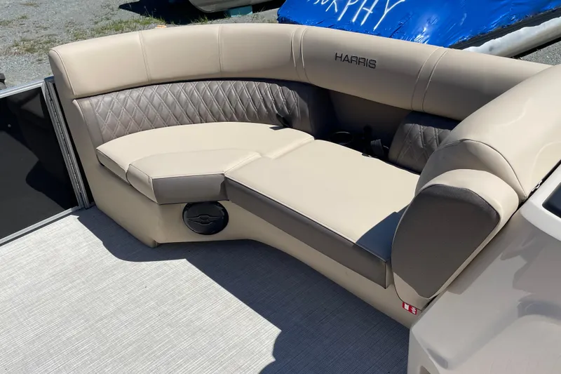 Slide: The Image of Luxurious seating on 2026 Harris Cruiser 210 pontoon boat, featuring beige and gray upholstery. - 6