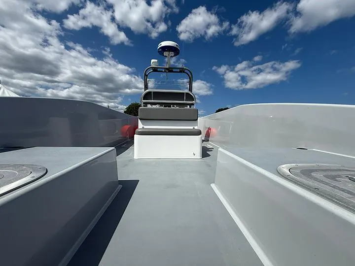 The Image of Custom T-33 PATROL boat deck under blue sky with clouds, 2022 model. - 0