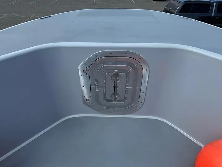 Slide: The Image of Custom T-33 PATROL 2022 boat deck with hatch, featuring sleek gray design. - 2