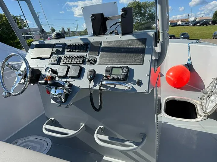 Slide: The Image of Control panel of 2022 Custom T-33 PATROL boat with steering wheel and communication devices. - 5