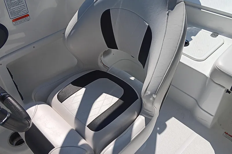Slide: The Image of Captain's seat in a 2017 Tahoe 1950 boat, featuring white and black upholstery. - 10
