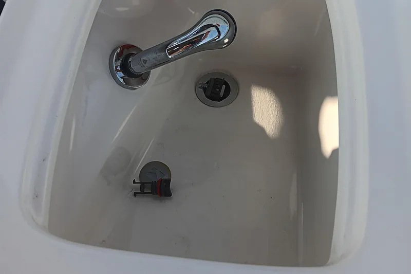 Slide: The Image of White sink with chrome faucet in a 2017 Tahoe 1950 boat. - 14