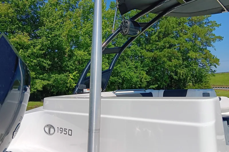 Slide: The Image of Tahoe 1950 boat from 2017, parked near lush green trees. - 15