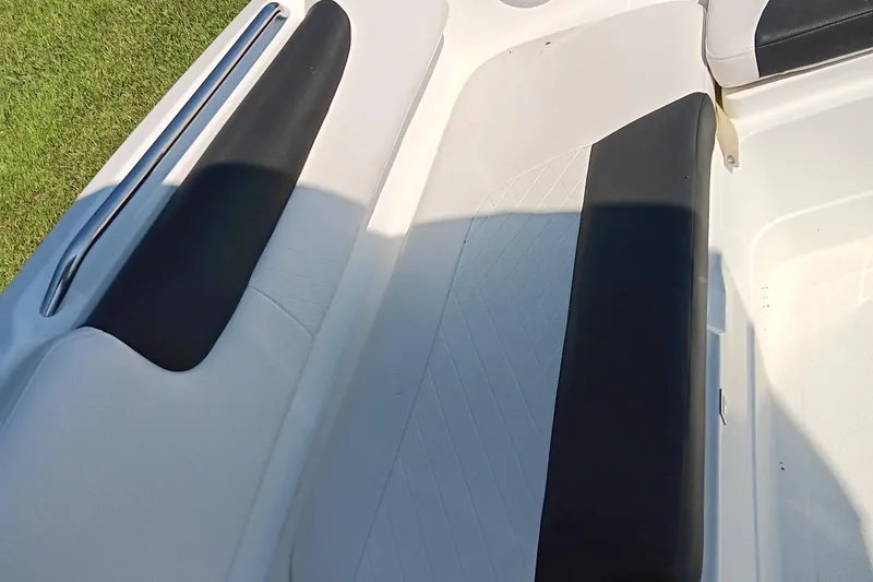 Slide: The Image of Interior seating of a 2017 Tahoe 1950 boat, featuring black and white upholstery. - 6