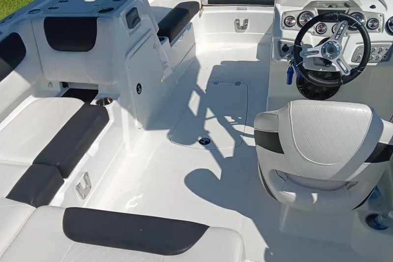 Slide: The Image of Interior of a 2017 Tahoe 1950 boat with white and black seating. - 9
