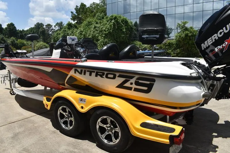 Slide: The Image of 2008 Nitro Z9CDC boat on a yellow trailer, parked outdoors. - 11