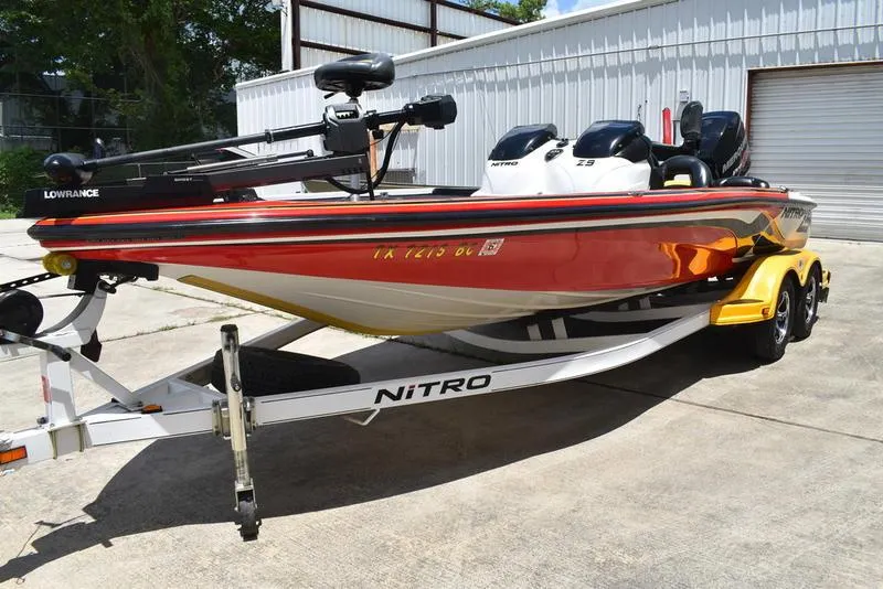 Slide: The Image of 2008 Nitro Z9CDC boat on trailer, red and white, parked outdoors. - 12